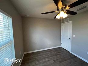 Cape Coral house for rent - a living room with a ceiling fan and a white door