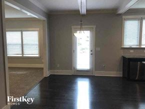 Pineville house for rent - A room with a door and a window with blinds.