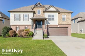 Clarksville house for rent - A house with a brown garage door is for sale.