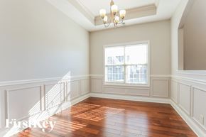 Clarksville house for rent - A room with wooden floors and a chandelier.