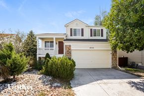 Fountain house for rent - a white house with a white garage door and a driveway