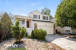 Fountain house for rent - a white house with a garage door and a gravel driveway