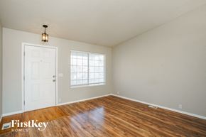 Fountain house for rent - the living room of a home with a wooden floor and a white door