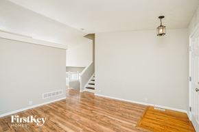 Fountain house for rent - a living room with a hard wood floor and a staircase
