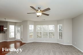 Hiram house for rent - A spacious room with a ceiling fan and a carpeted floor.