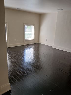 Louisville apartment for rent - an empty living room with wooden floors and a window