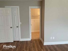 Fleming Island house for rent - an empty bedroom with a closet and a door to a hallway