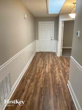 Fleming Island house for rent - a hallway with wood floors and a white door