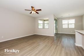San Tan Valley house for rent - the living room and dining room with wood flooring and a ceiling fan