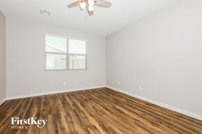San Tan Valley house for rent - a bedroom with white walls and wood flooring and a window