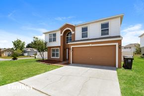 Davenport house for rent - A two-story house with a brown garage door is for sale.