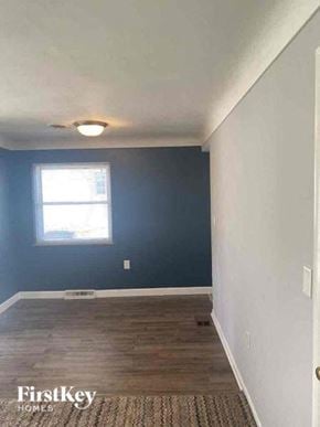 Cincinnati house for rent - an empty room with a blue wall and a window