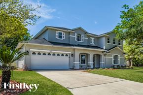 Jacksonville house for rent - A house with a grey roof and a garage door is shown.