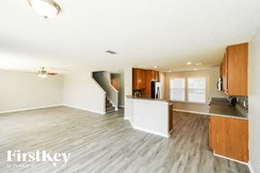 Jacksonville house for rent - A spacious kitchen and living room with wooden floors and white walls.
