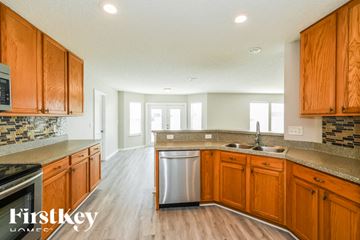 Jacksonville house for rent - A kitchen with wooden cabinets and a stainless steel dishwasher.