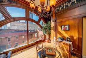 Louisville house for rent - a dining room with a large window and a chandelier
