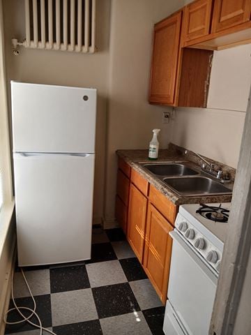 Louisville apartment for rent - a small kitchen with a sink and a refrigerator
