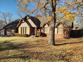 Tulsa house for rent - a house with a tree in front of it