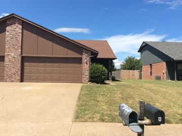 Tulsa house for rent - a house with a driveway and a parking meter in front of it