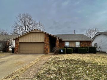 Broken Arrow house for rent - a brown brick house with a brown garage door