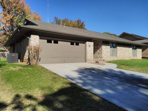 Tulsa house for rent - A house with a grey roof and a grey garage door.