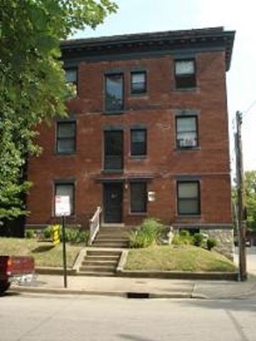 Louisville apartment for rent - A red brick building with a sign in front of it.
