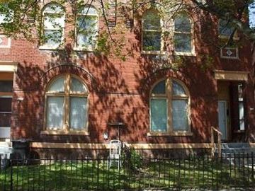 Louisville apartment for rent - a red brick building with windows and a fence