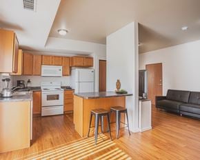 Watford City apartment for rent - A kitchen with wooden cabinets and a white refrigerator.