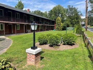 Westfield apartment for rent - a lamp post sitting in the grass in front of a building