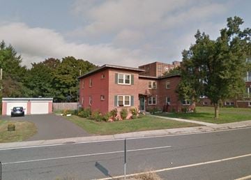 Holyoke apartment for rent - a red brick house on the side of a street