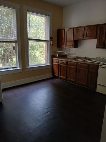 Louisville apartment for rent - A kitchen with wooden cabinets and a white dishwasher.