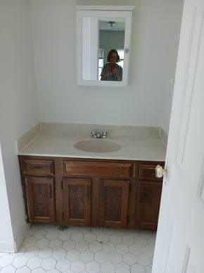 Louisville apartment for rent - A bathroom with a sink and a mirror.