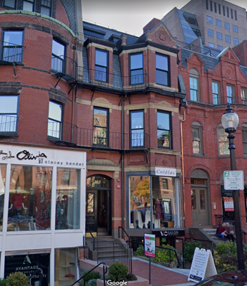 Boston apartment for rent - A street view of a red brick building with a storefront on the ground floor.