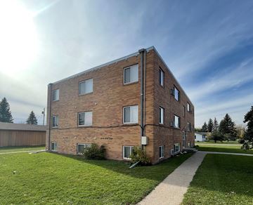 Devils Lake apartment for rent - a brick apartment building on the side of a sidewalk