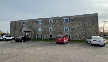 Devils Lake apartment for rent - an apartment building with cars parked in front of it