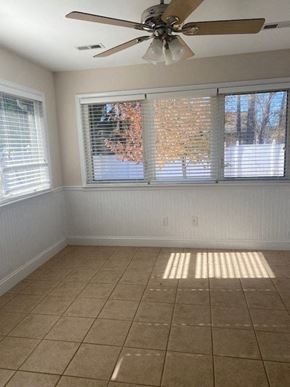 Rome apartment for rent - A room with a ceiling fan and tiled floor.