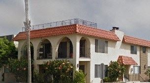 San Clemente apartment for rent - A white house with a red tile roof and a balcony with a railing.