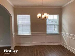 Denver house for rent - a dining room with a chandelier and two windows