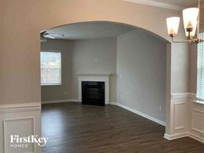 Denver house for rent - an empty living room with a fireplace