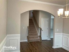 Denver house for rent - a living room with a staircase and a white door