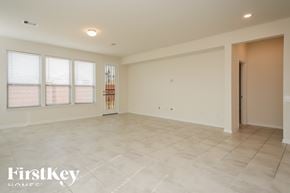 Richmond house for rent - A spacious room with a tiled floor and a large window with blinds.