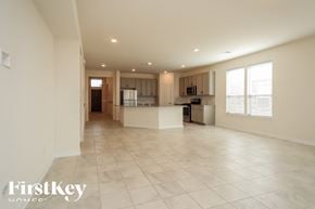 Richmond house for rent - A spacious, empty room with a kitchen area in the background.