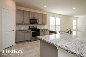 Richmond house for rent - A kitchen with granite countertops and a FirstKey Homes logo.