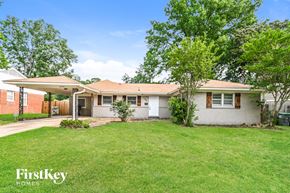 Memphis house for rent - A house with a lawn and trees in front of it.