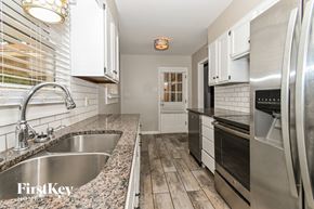 Memphis house for rent - A kitchen with a stainless steel refrigerator and a granite countertop.