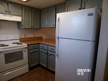 Cottonwood apartment for rent - A kitchen with a white refrigerator and a white stove.