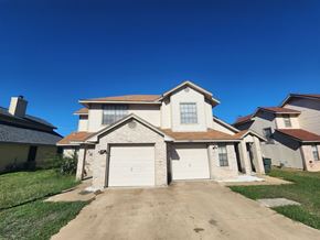 Killeen apartment for rent - A two-story house with a garage is situated in a residential area.