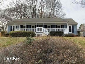 Charlotte house for rent - a blue house with a white porch on a hill