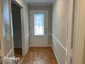 Charlotte house for rent - a hallway with a door and a wood floor