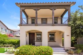 Goodyear house for rent - A two-story house with a balcony and a front door.